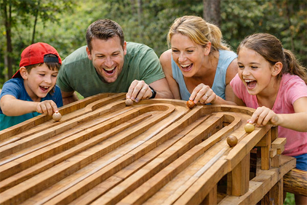 "family fun with wooden marbles at beyond the trees avondale"